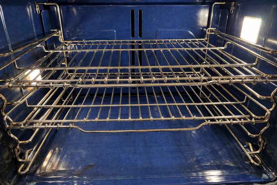 Detailed cleaning around a residential oven